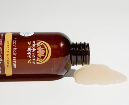 Wholesome Hippy hair thickening protectant serum bottle showing the lightweight formula texture.