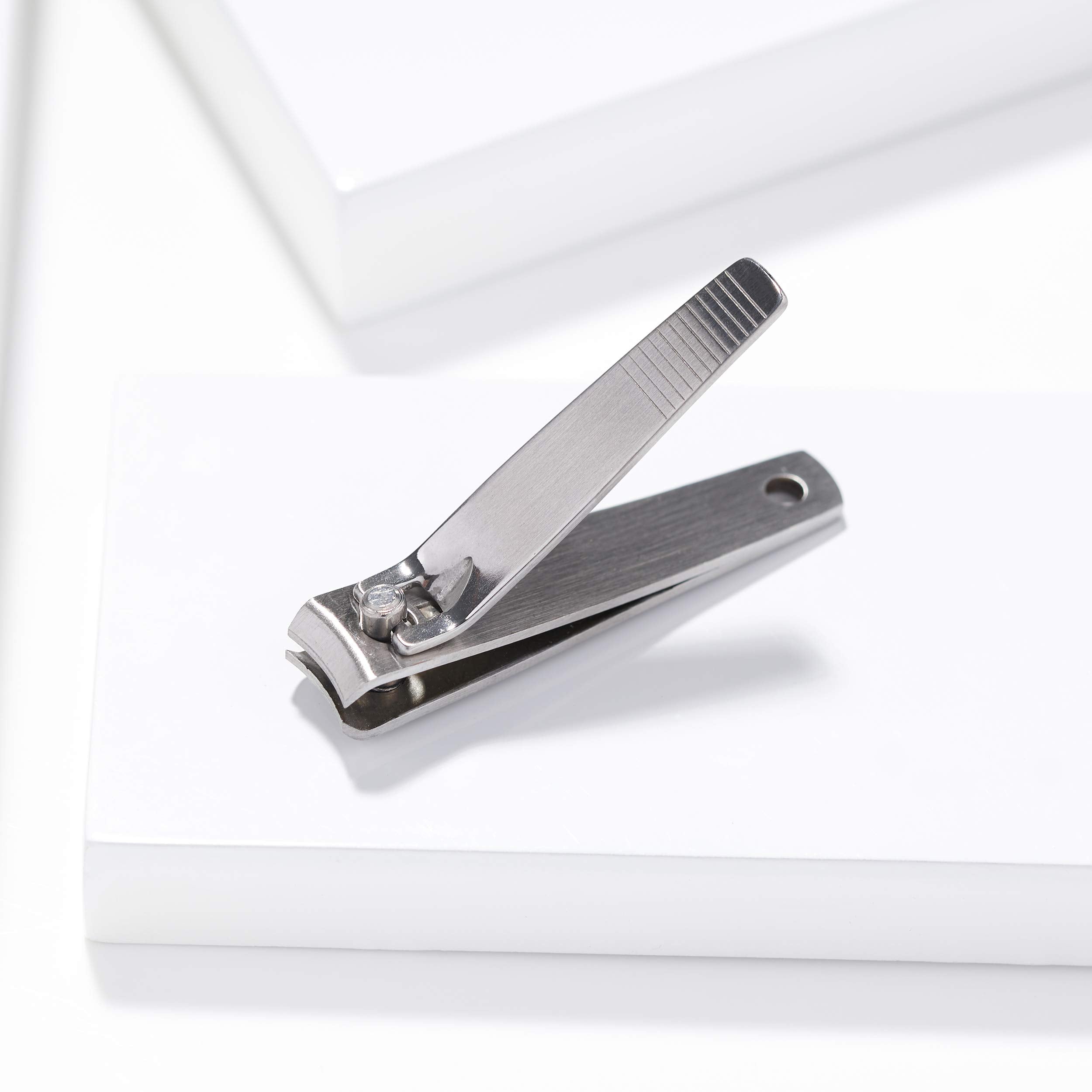 Tweezerman stainless steel nail grooming tool held in hand