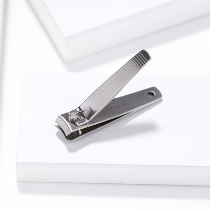 Tweezerman stainless steel nail grooming tool held in hand