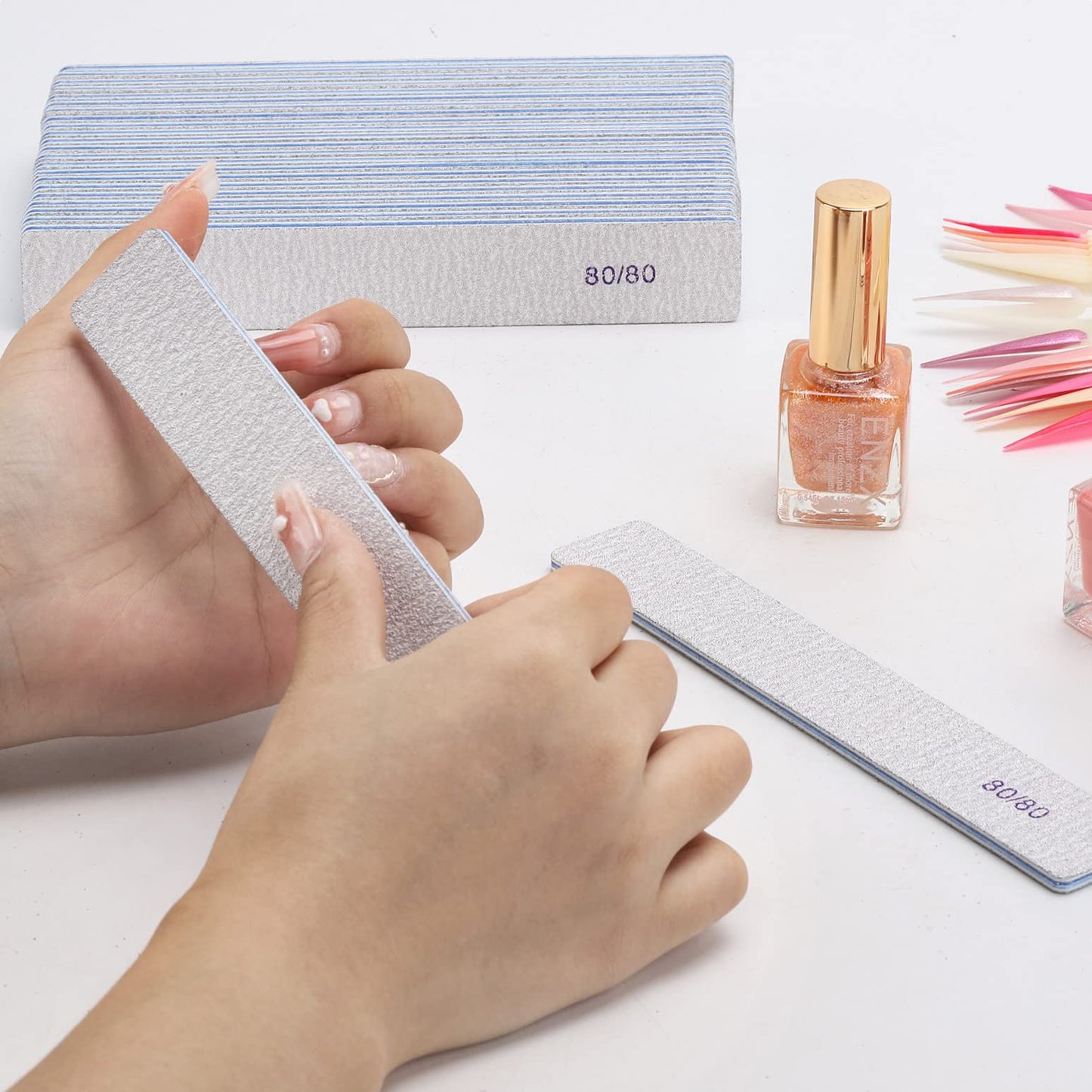 Professional nail technician using Btyms emery board for shaping