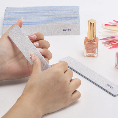 Professional nail technician using Btyms emery board for shaping