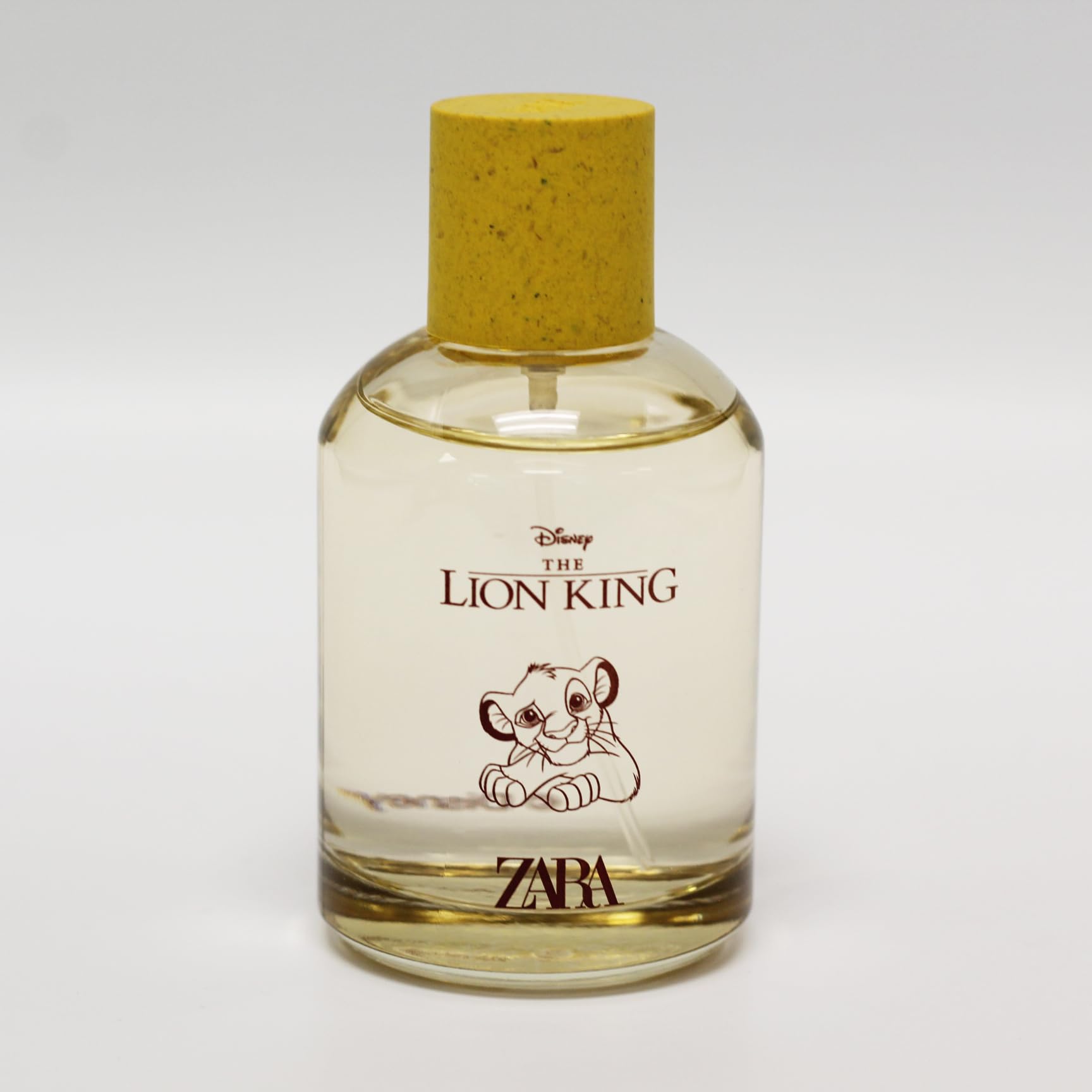 Zara The Lion King eau de toilette spray for children next to its yellow cylindrical gift box packaging