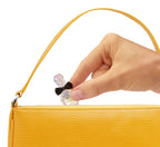 Applying a drop of the mixed miniature fragrance onto a wrist to demonstrate cosmetic usage.