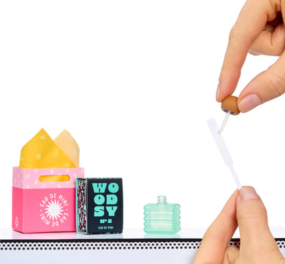 Full collection of twelve distinct miniature perfume styles showcased together on display racks.