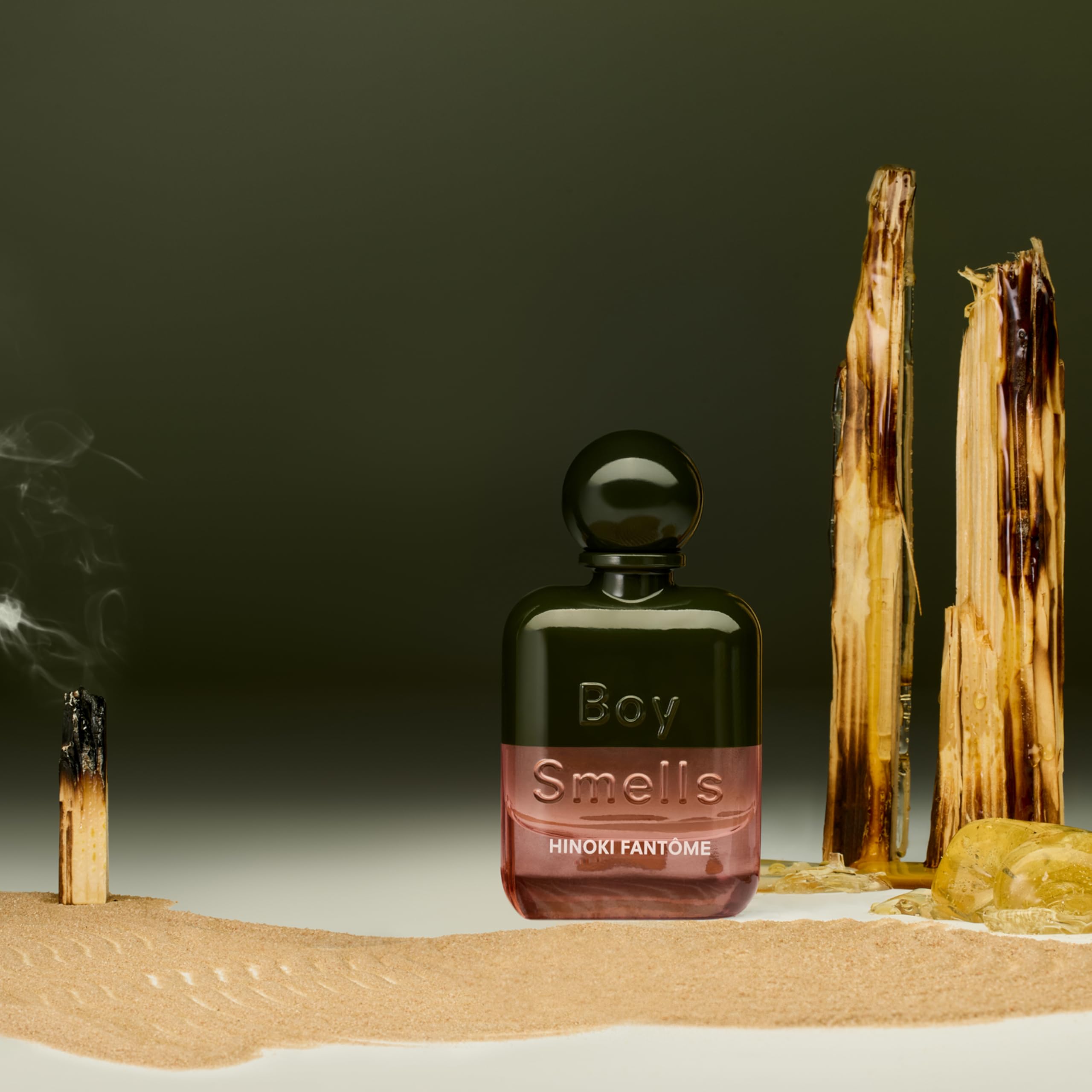 Premium glass bottle of Boy Smells gender neutral fragrance on plain background
