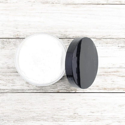 Belle and Kat luxury personal care dusting powder jar displaying ingredient information for sensitive skin protection.