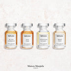 Maison Margiela Replica travel perfume miniature set showing four aesthetic apothecary style splash bottles.