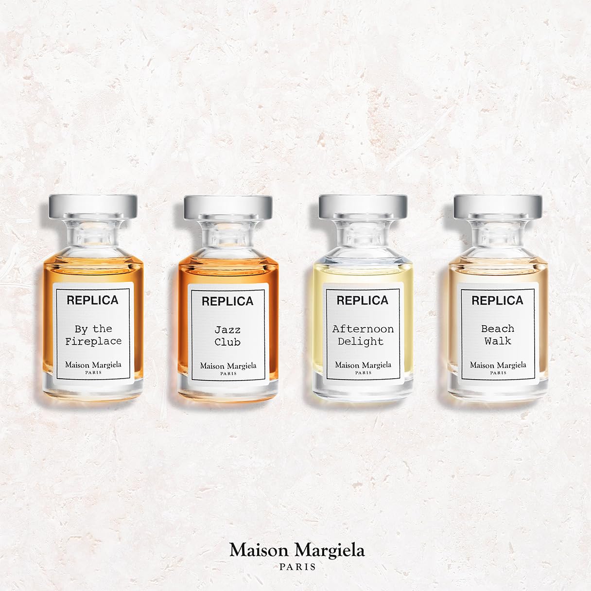 Maison Margiela Replica travel perfume miniature set showing four aesthetic apothecary style splash bottles.