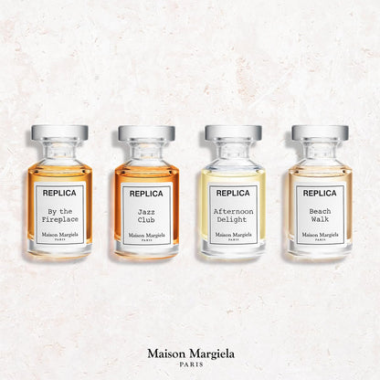 Maison Margiela Replica travel perfume miniature set showing four aesthetic apothecary style splash bottles.
