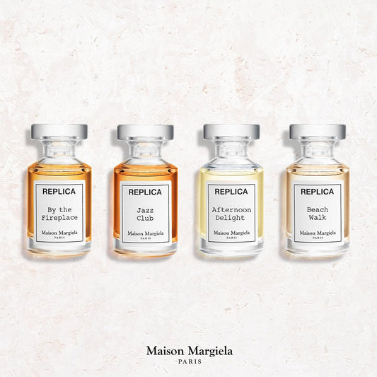 Maison Margiela Replica travel perfume miniature set showing four aesthetic apothecary style splash bottles.