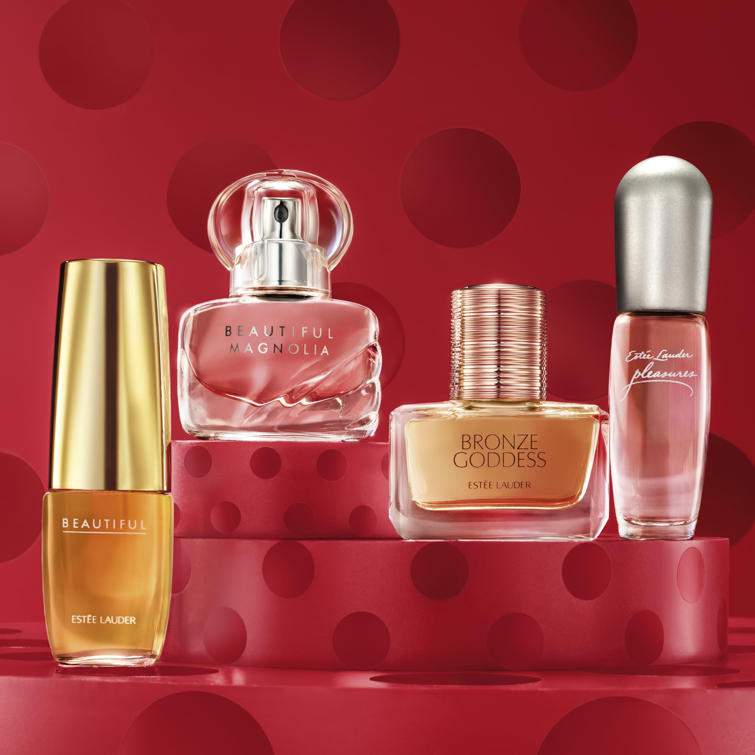 Four Estee Lauder miniature perfumes lined up in gift box