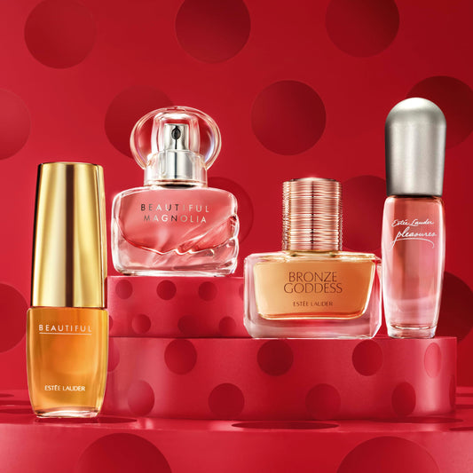 Four Estee Lauder miniature perfumes lined up in gift box