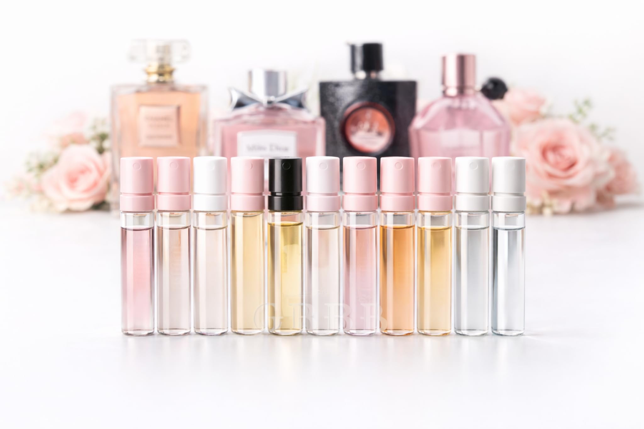 A collection of twelve premium designer perfume sample vials for women spread out neatly.