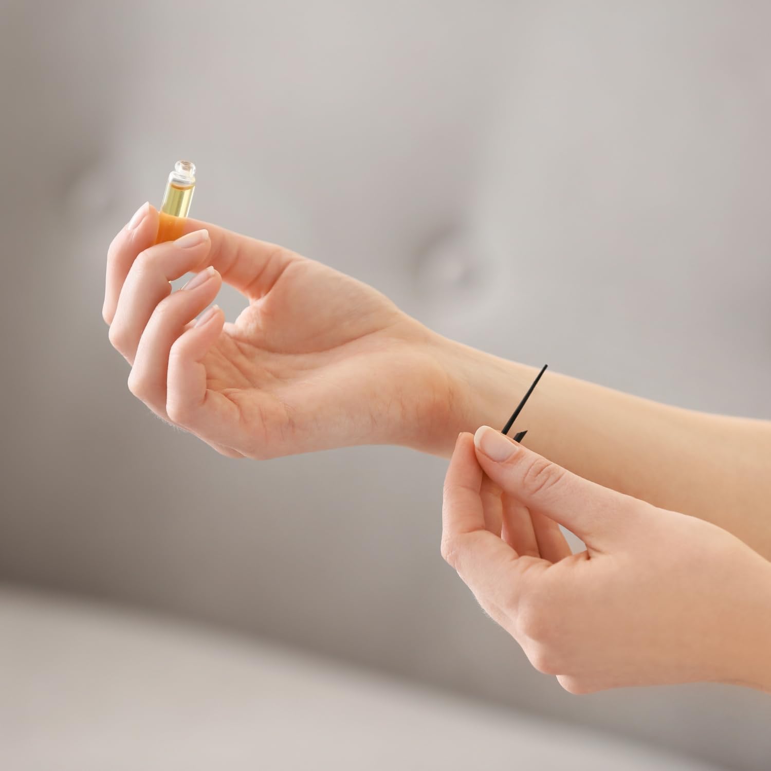 Luxury fragrance discovery kit featuring twelve assorted miniature perfume vials for women on a clean backdrop.