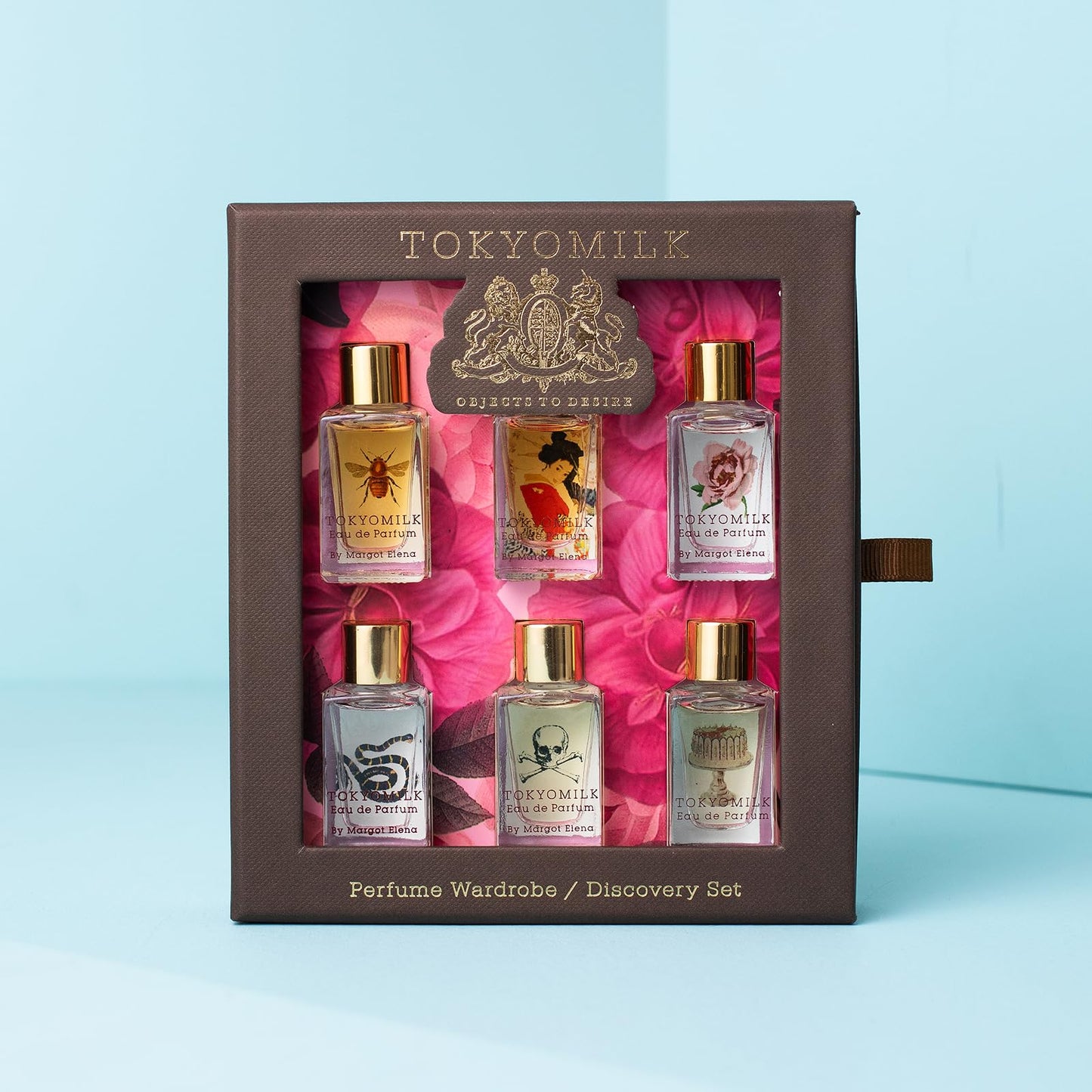 Six miniature TokyoMilk Classic perfume dabber bottles displayed in a row