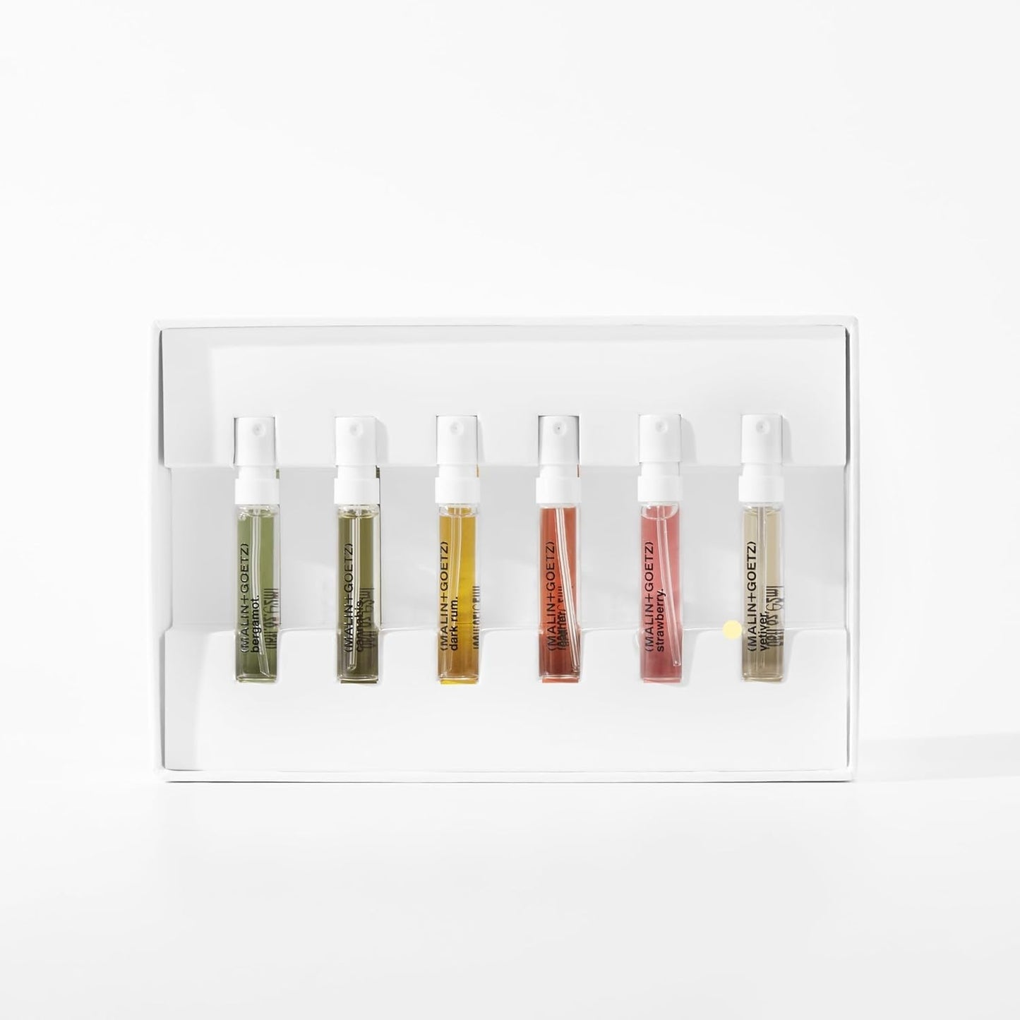MALIN+GOETZ perfume discovery set opened to display the six travel-sized unisex spray bottles arranged neatly inside.