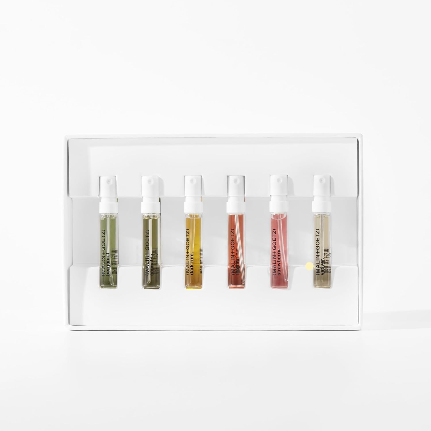 MALIN+GOETZ perfume discovery set opened to display the six travel-sized unisex spray bottles arranged neatly inside.