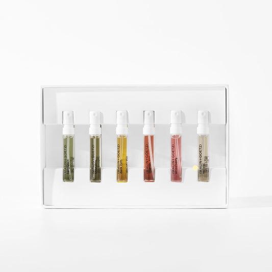 MALIN+GOETZ perfume discovery set opened to display the six travel-sized unisex spray bottles arranged neatly inside.