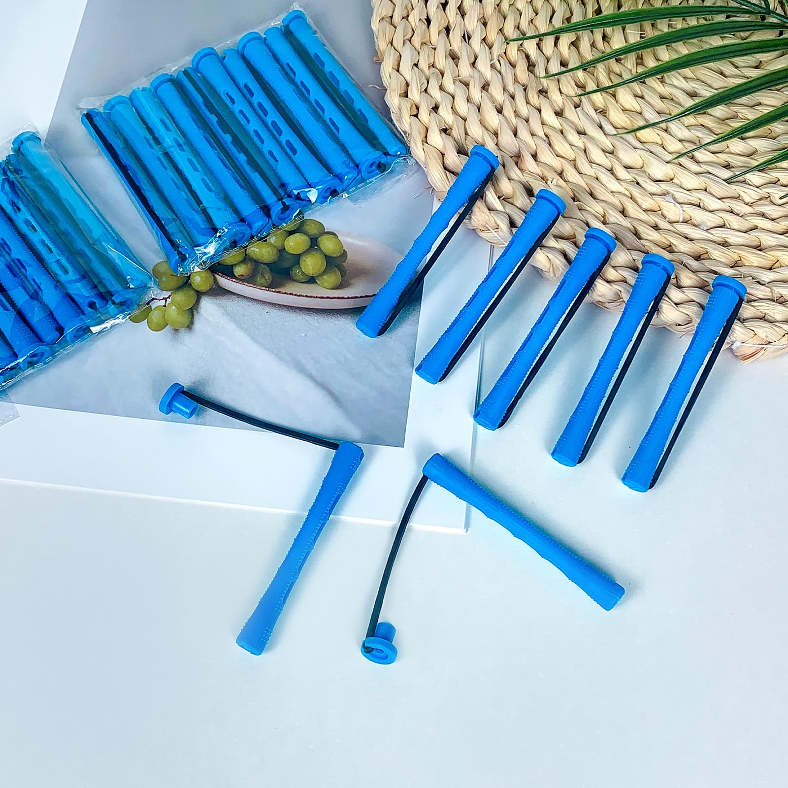 Professional hairdressing tools including blue cold wave perming rods.