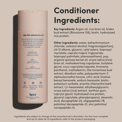 Textured flat lay of Hers shampoo and conditioner bottles