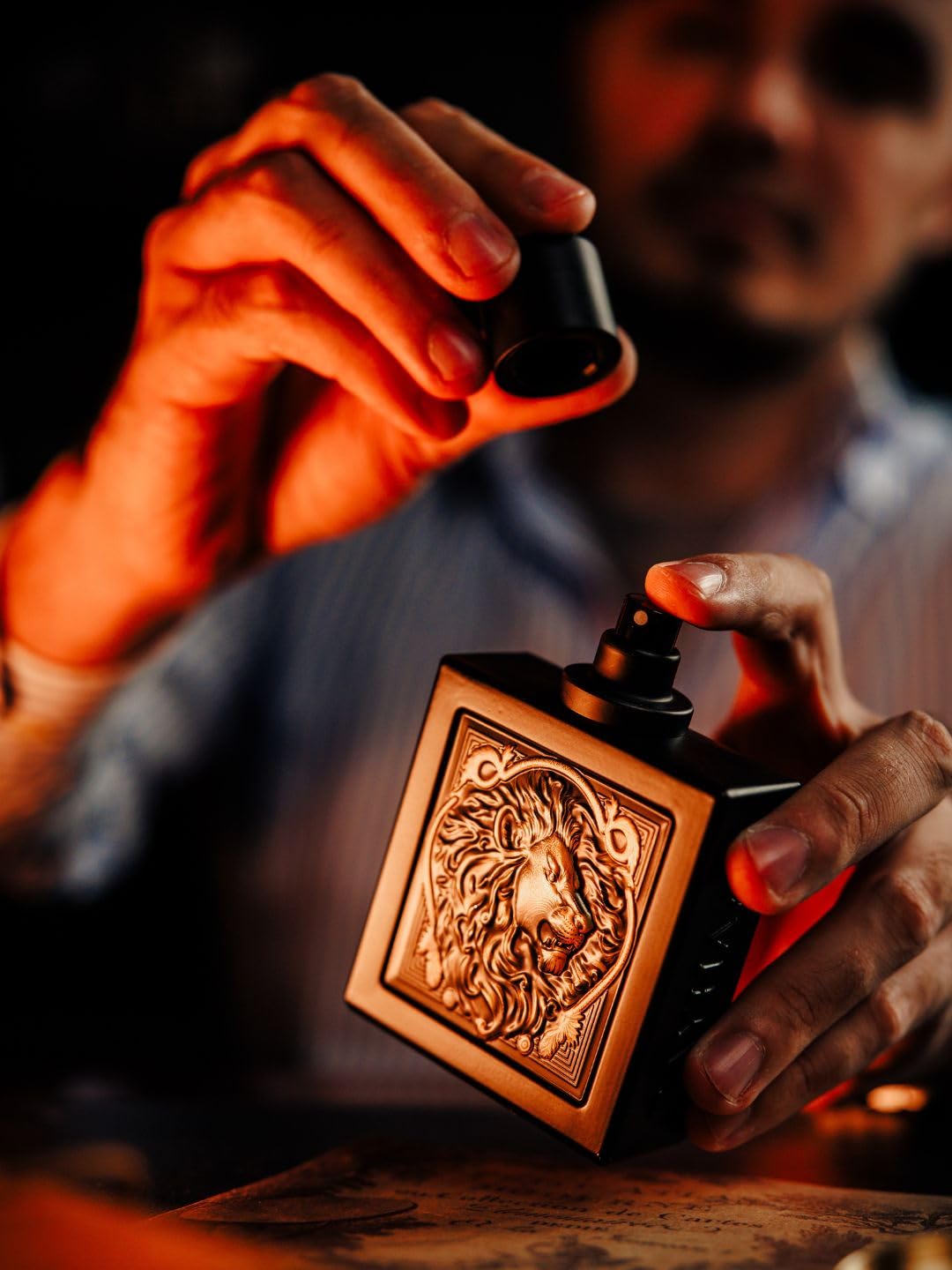 Rayhaan Lion 100ml long lasting men's fragrance display highlighting the signature gold details.