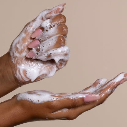 Cantu sulfate free cream shampoo texture alongside the product bottle packaging