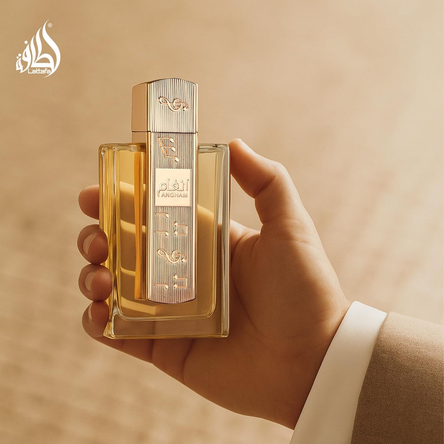 Lattafa Angham luxury arabian perfume bottle held showing its true size and elegant golden design accents.