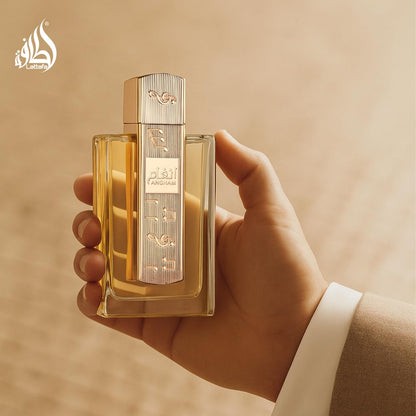 Lattafa Angham luxury arabian perfume bottle held showing its true size and elegant golden design accents.