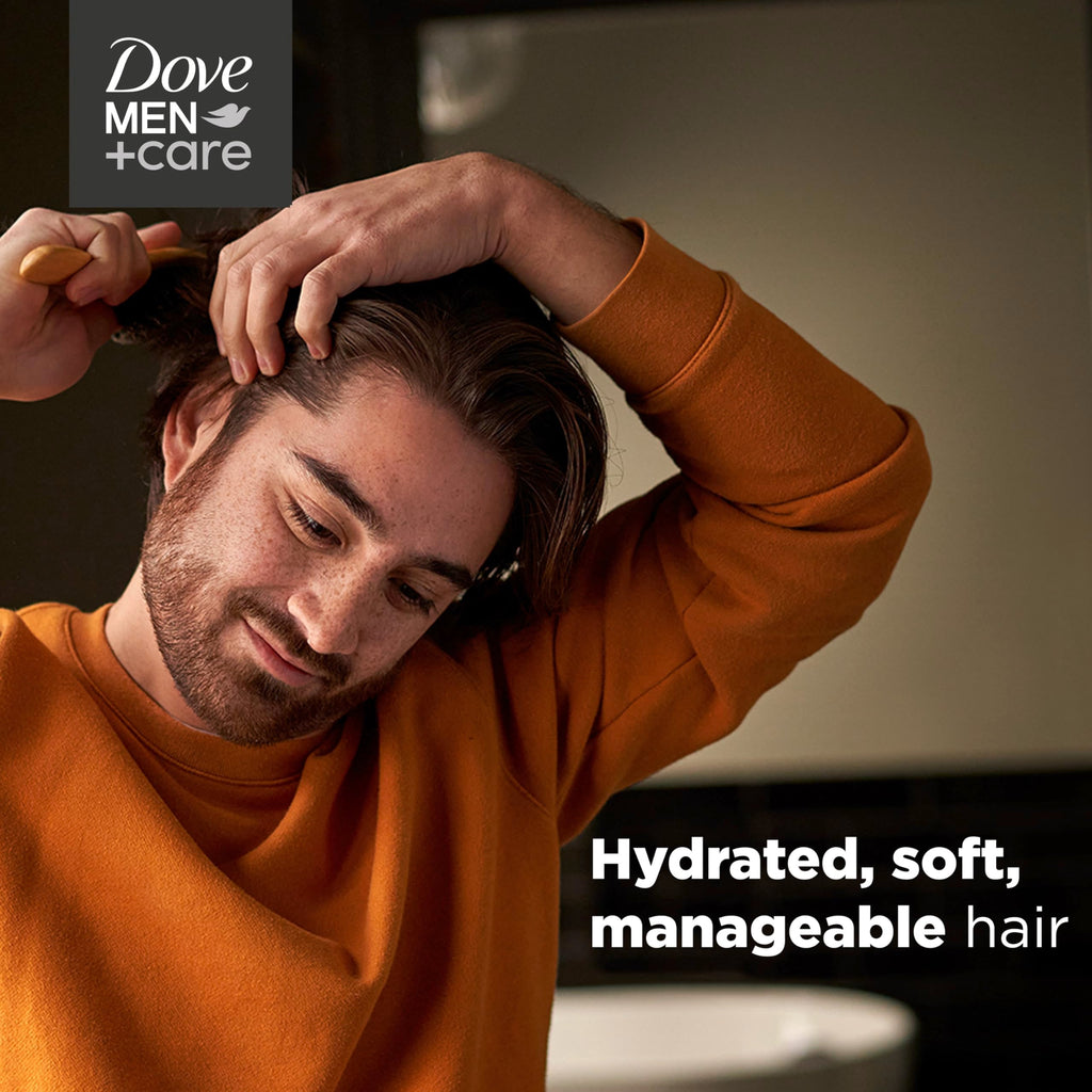 Dove Men Plus Care shampoo bottle held in hand for scale