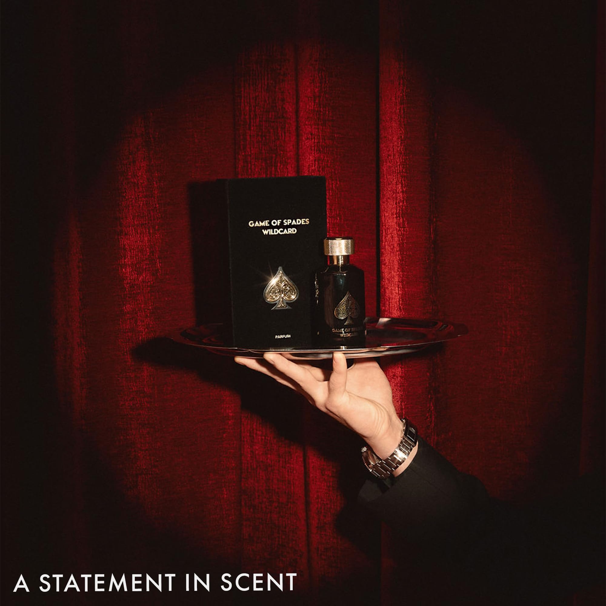 Jo Milano Game of Spades Wildcard unisex perfume bottle unboxed standing next to its elegant display carton.