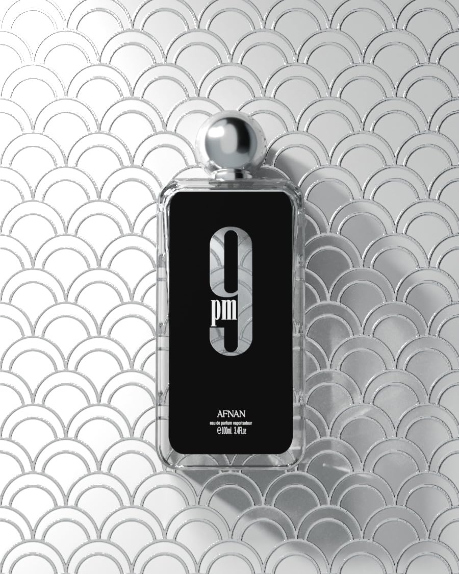 Afnan 9 PM heavy glass cologne bottle unboxed resting on a modern vanity.