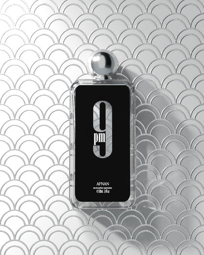 Afnan 9 PM heavy glass cologne bottle unboxed resting on a modern vanity.