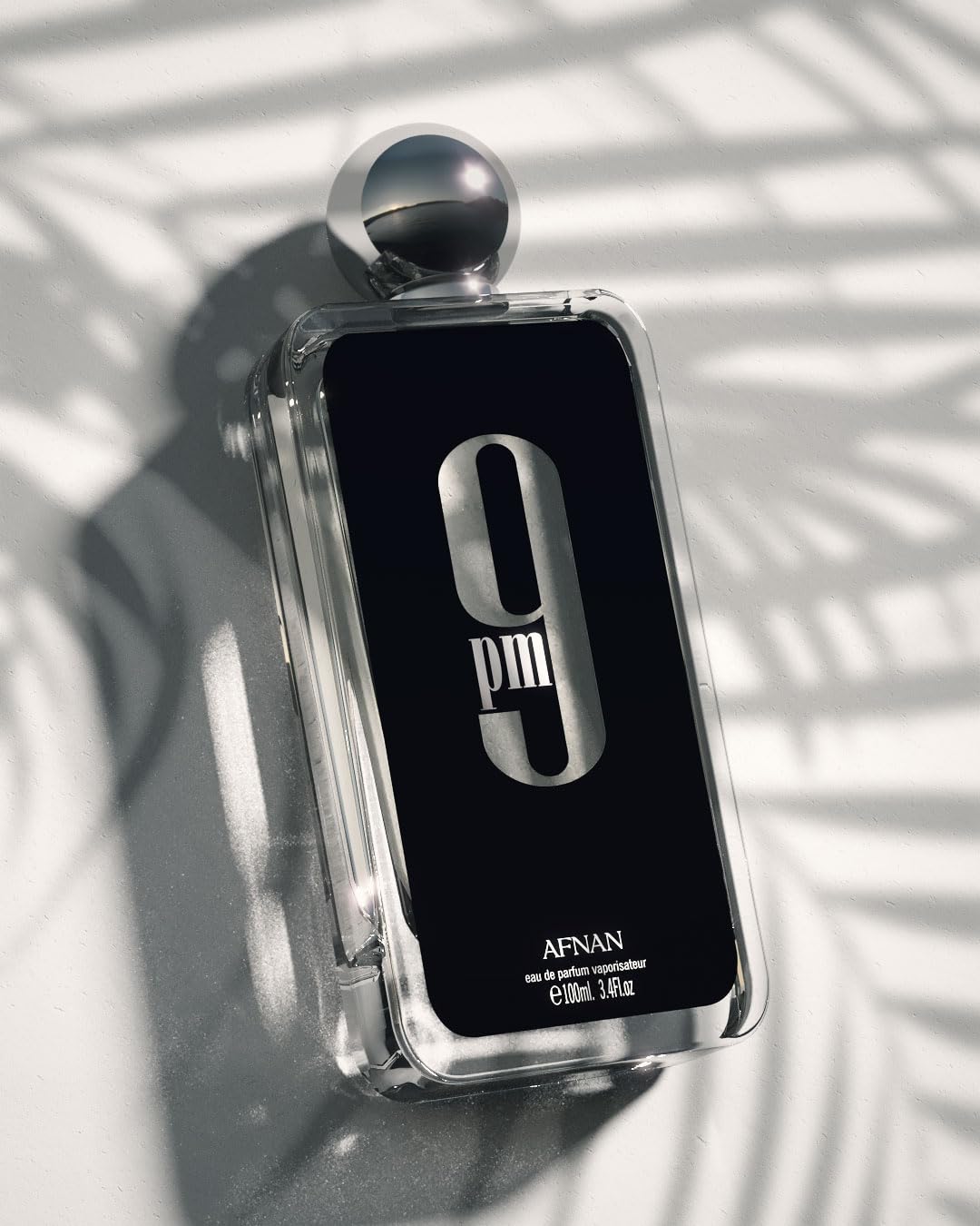 Side view of Afnan 9 PM Edition bottle emphasizing its elegant minimalist design.