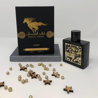 Lattafa Qaed Al Fursan pineapple and amber wood aromatic perfume bottle on a sleek background