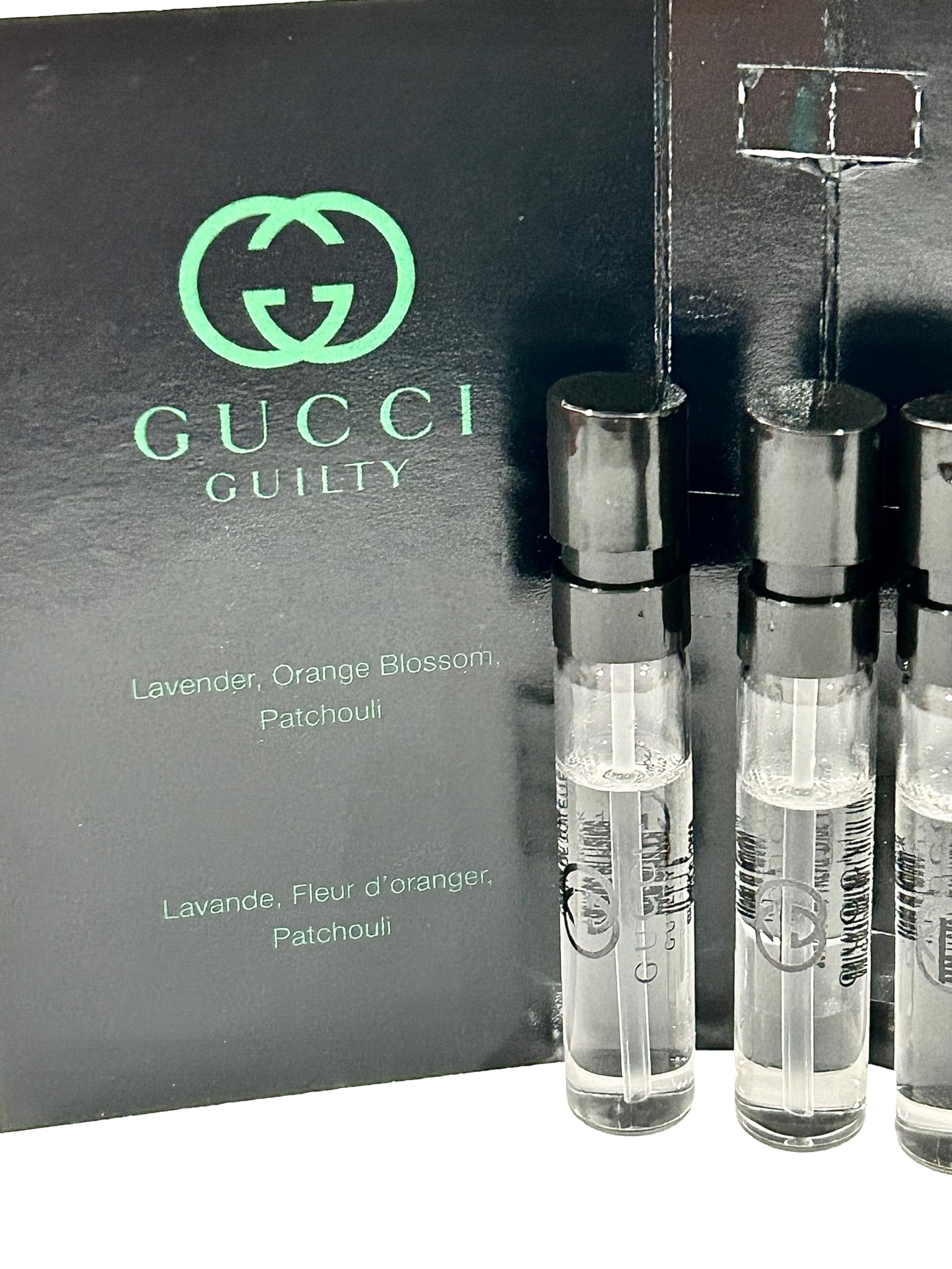 Gucci aromatic fougere men's fragrance sample set displaying product information text and cardboard backing