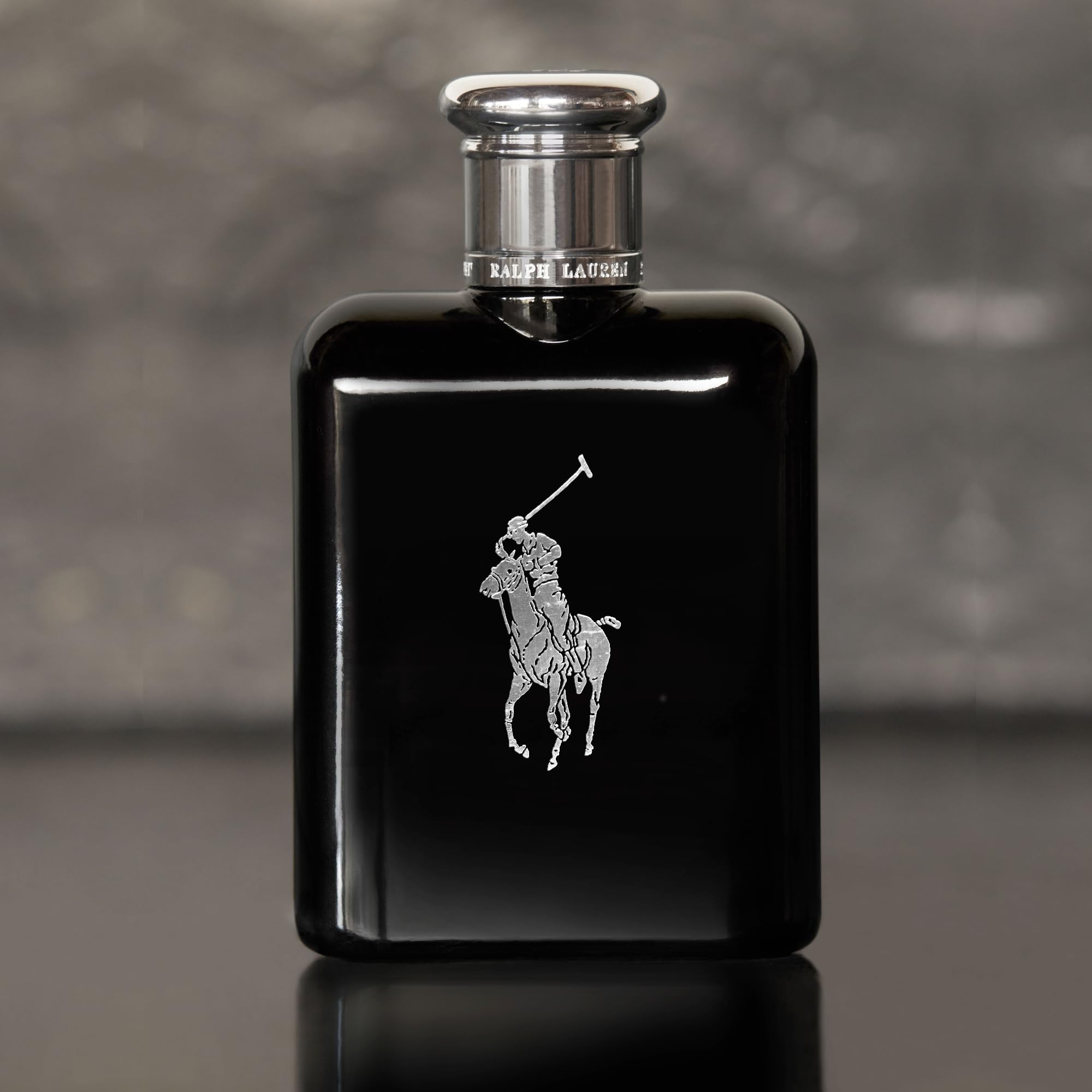 Close up of the signature silver polo player emblem on the Polo Black glass bottle