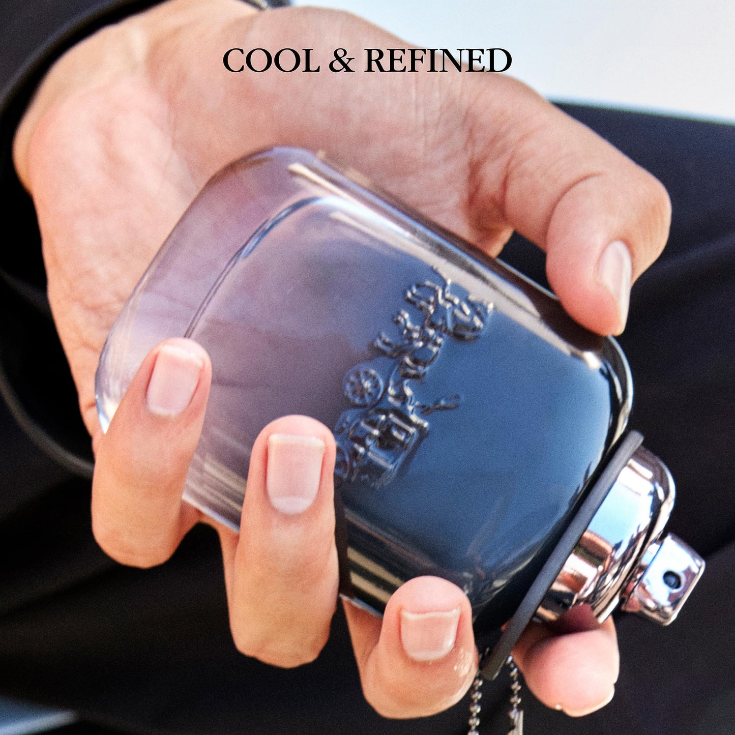 Side view of Coach signature cologne bottle illustrating the embossed horse and carriage logo