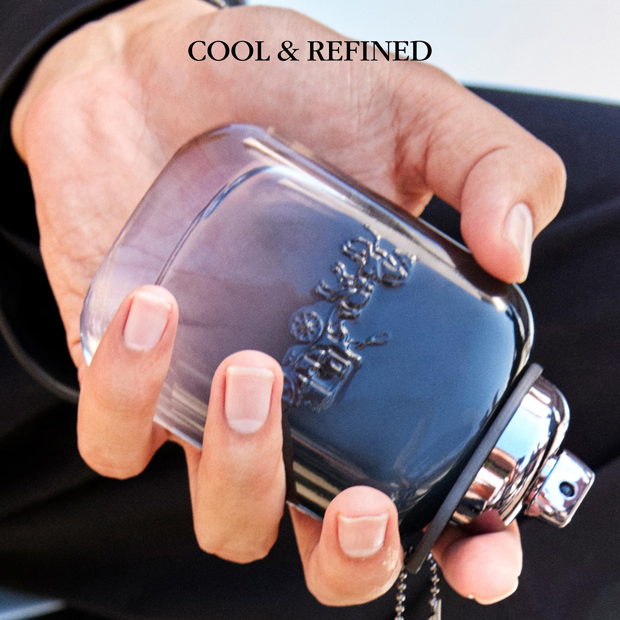 Side view of Coach signature cologne bottle illustrating the embossed horse and carriage logo