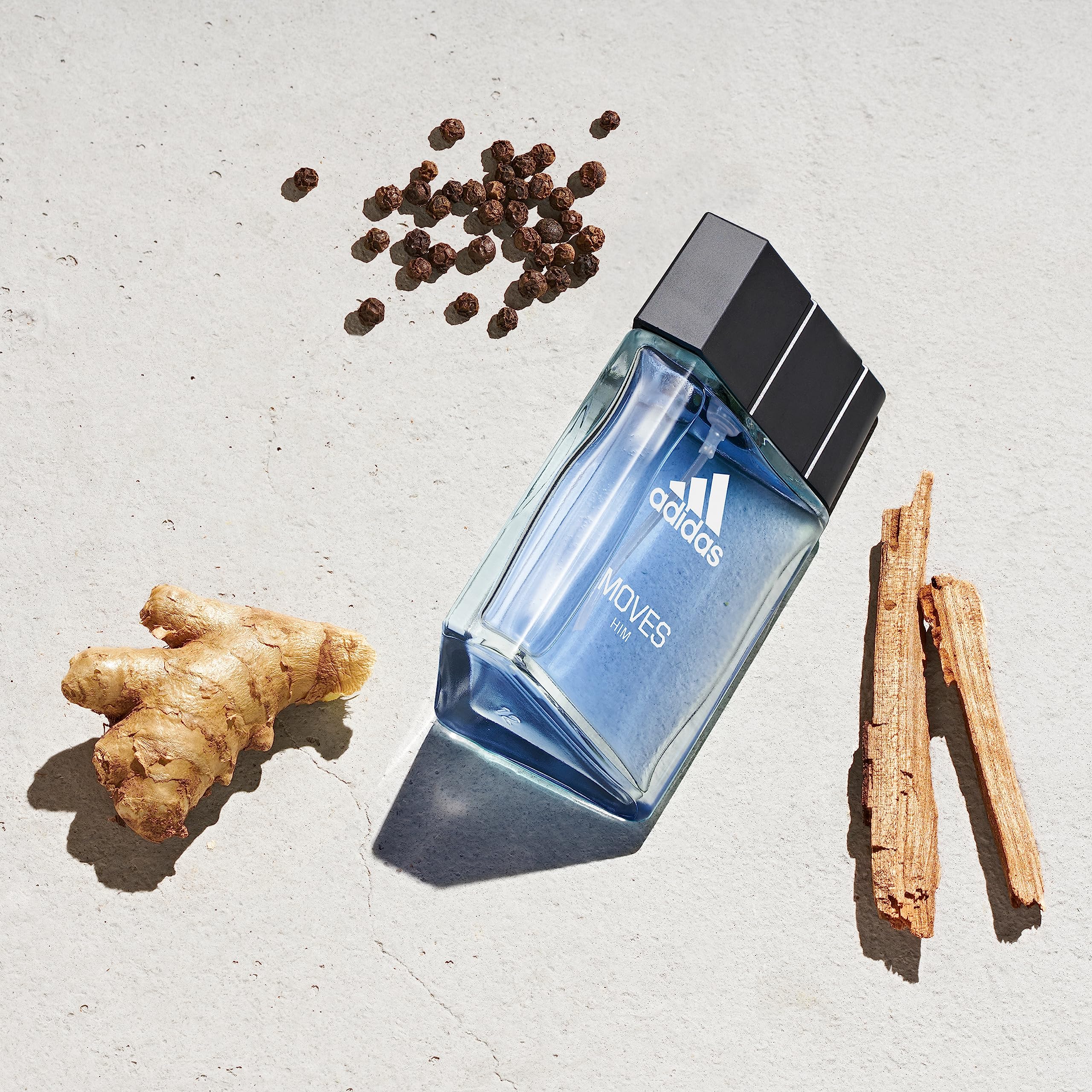 Adidas Moves for Men perfume spray bottle showcasing the crisp blue fragrance liquid