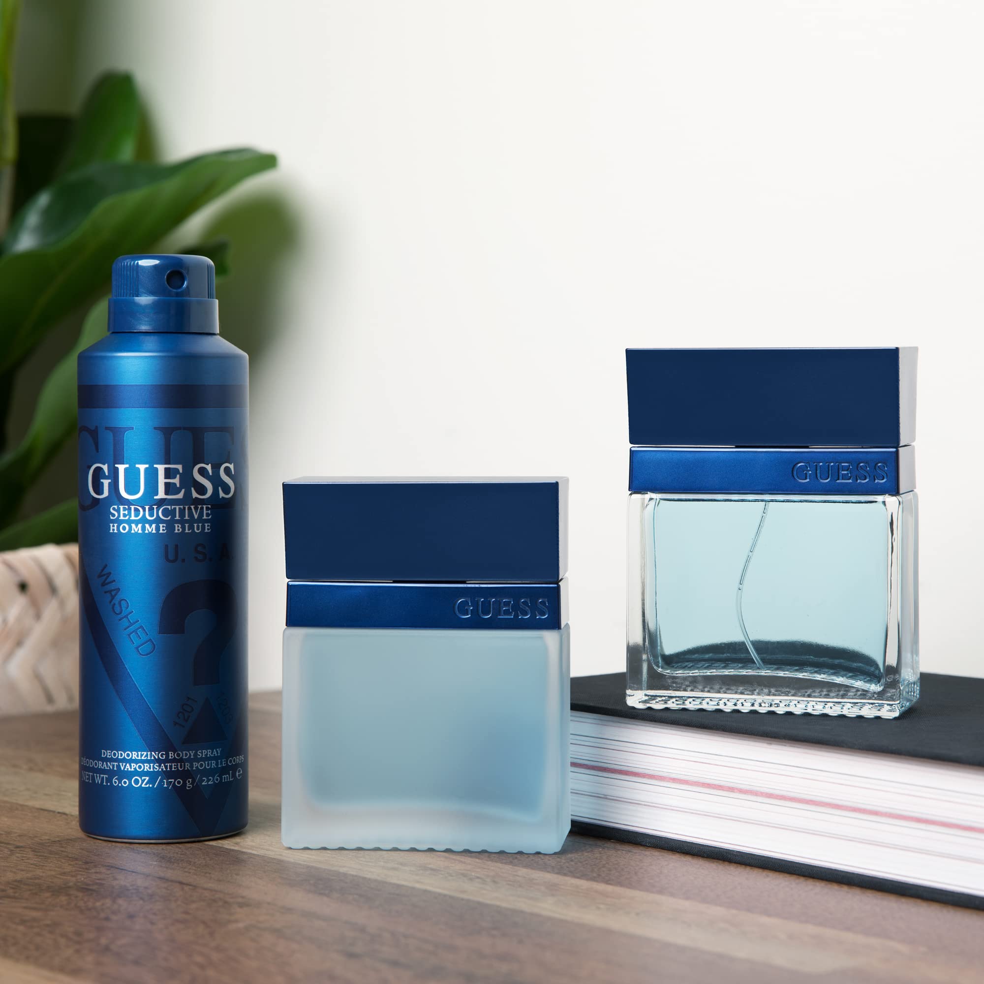 GUESS Seductive Homme Blue woody aquatic men's cologne spray unboxed showing the clear glass construction and blue liquid