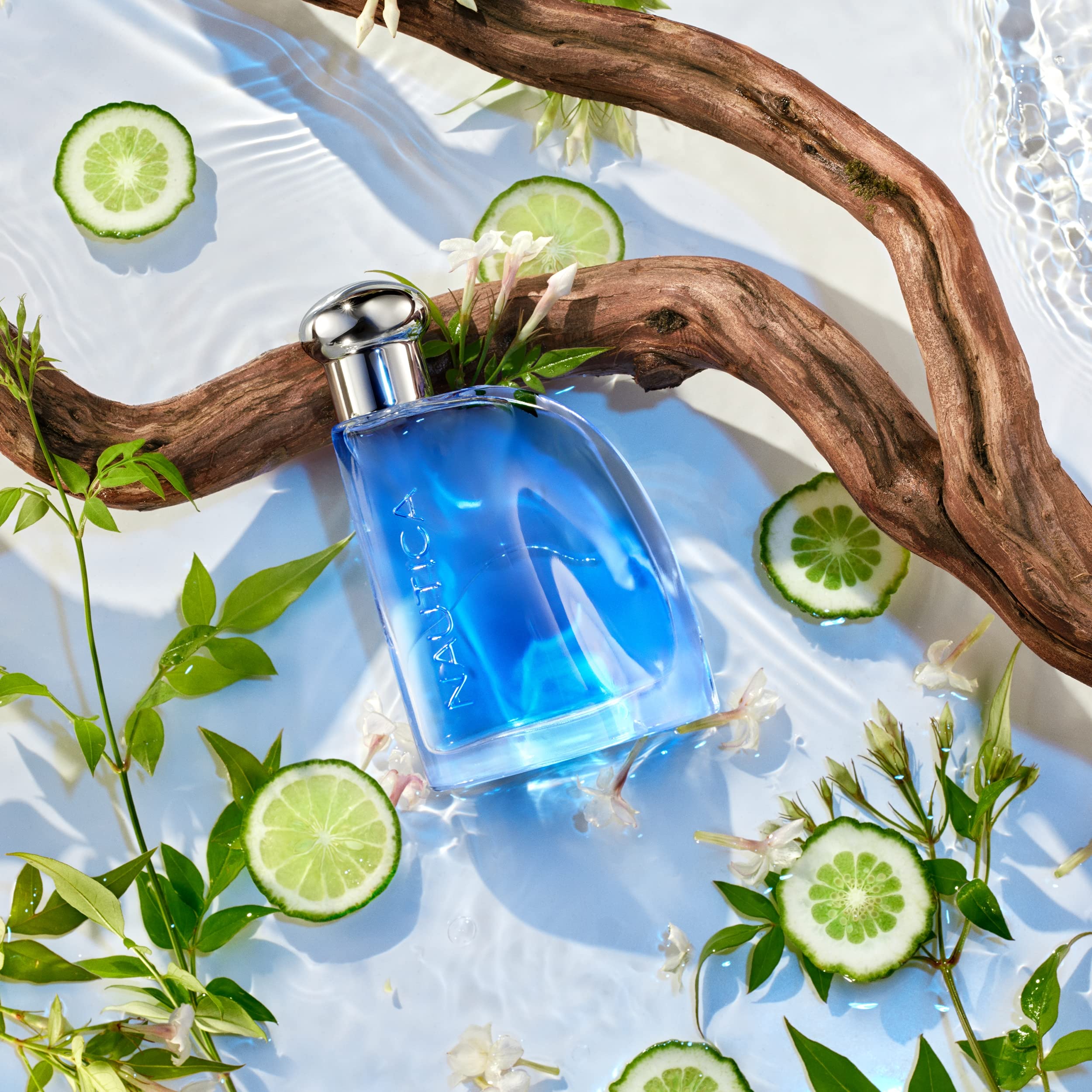 Nautica Blue Eau de Toilette bottle placed next to its official retail carton box on a clean backdrop.