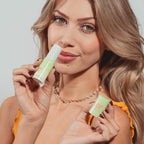 Model applying the Sweetums vanilla fragrance stick directly to pulse points on her wrist.