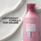 Redken Volume Injection Conditioner bottle with branding