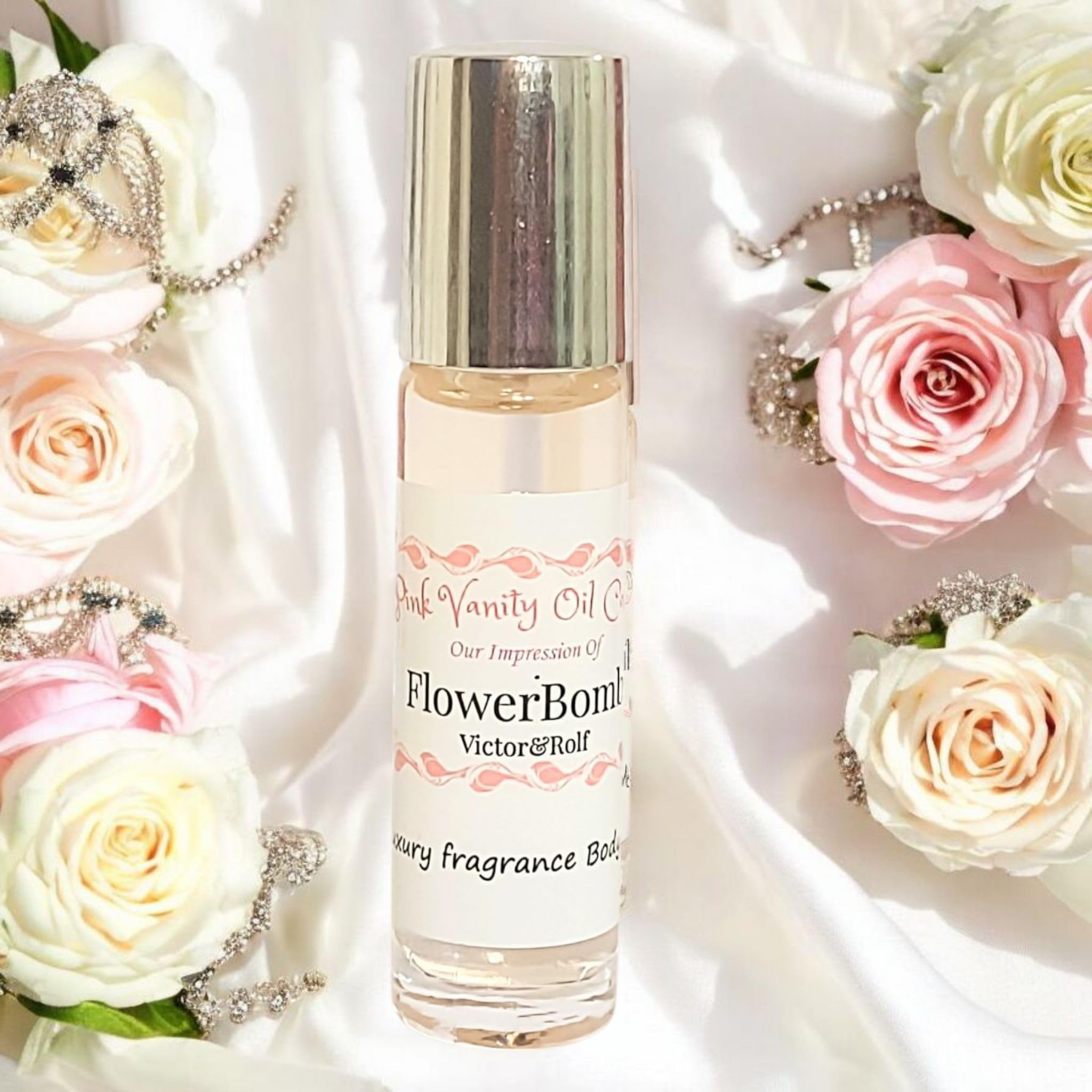 Pink Vanity Oil Co roll-on fragrance oil bottle with cap off showing roller ball mechanism