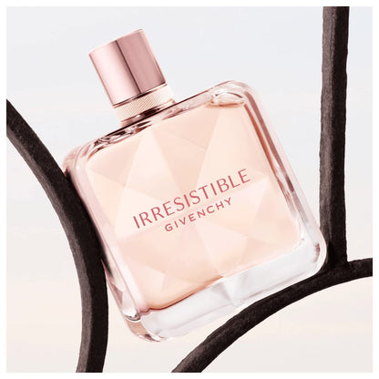 Side view of Givenchy Irresistible pink tinted glass perfume bottle
