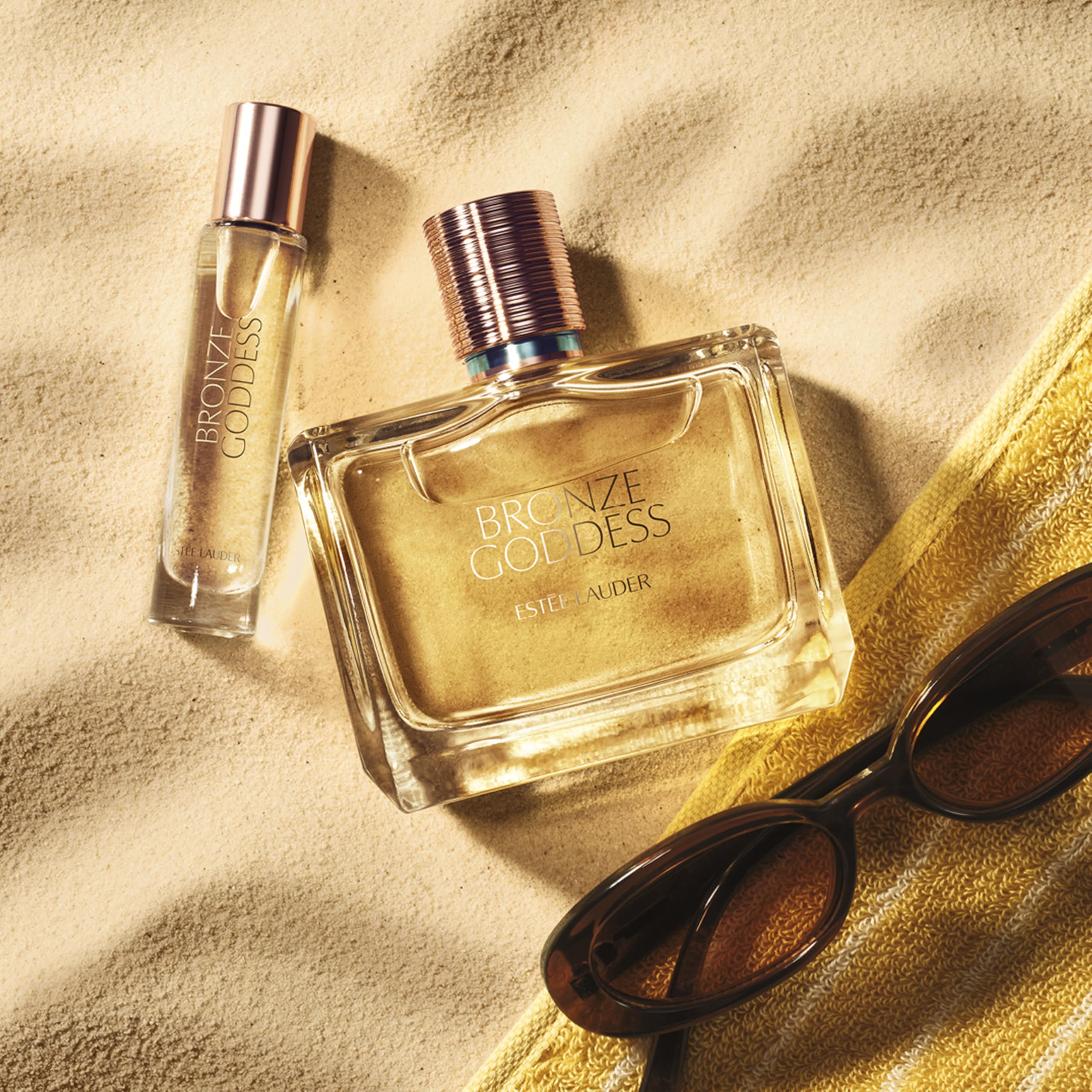 Estée Lauder Bronze Goddess 10mL perfume bottle on a vanity table