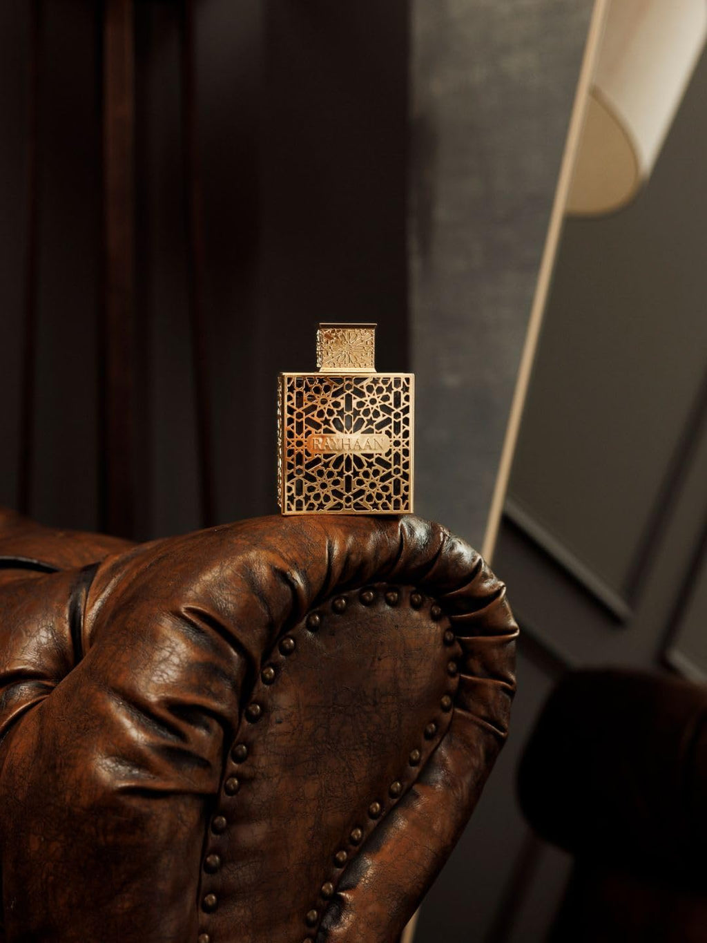Rayhaan Elixir Eau de Parfum 3.4 Ounce collectible bottle showing the rich liquid through the gold cage detail.