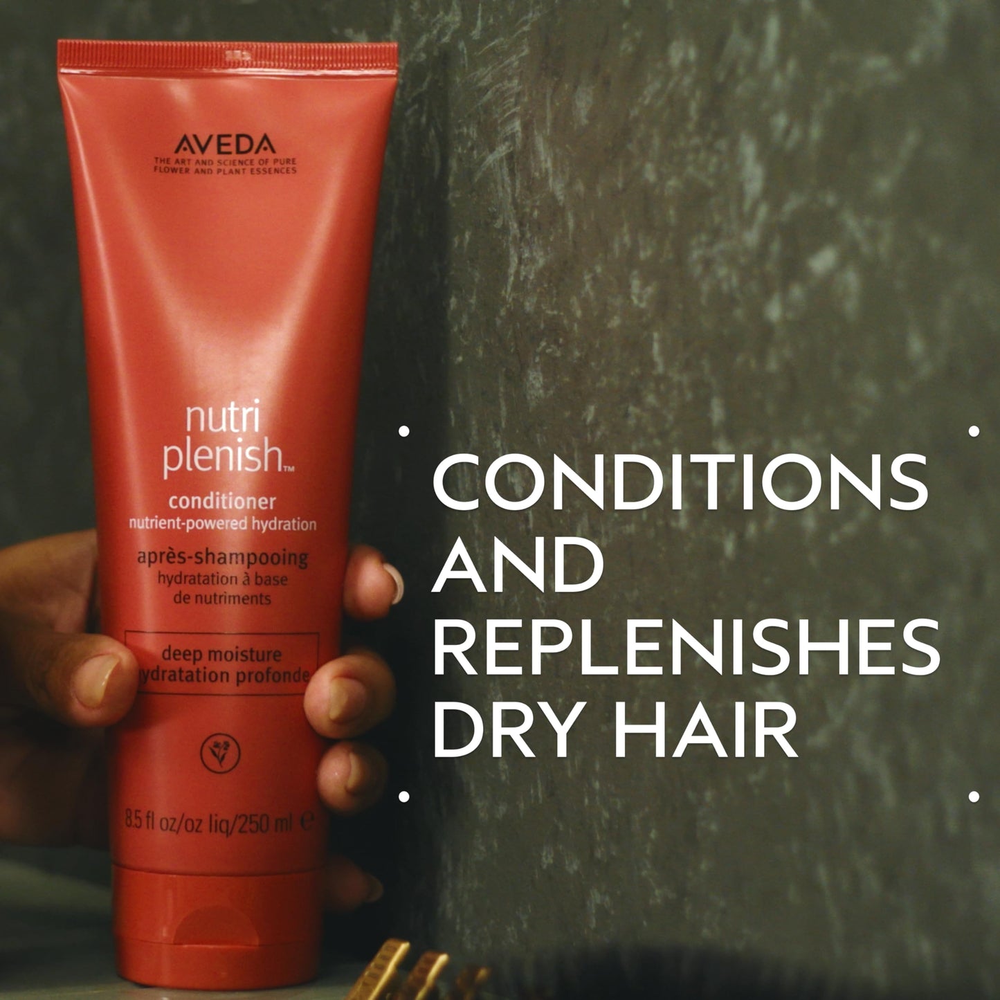Aveda deep hydration travel size hair conditioner tube resting upright on a clean minimalist surface.