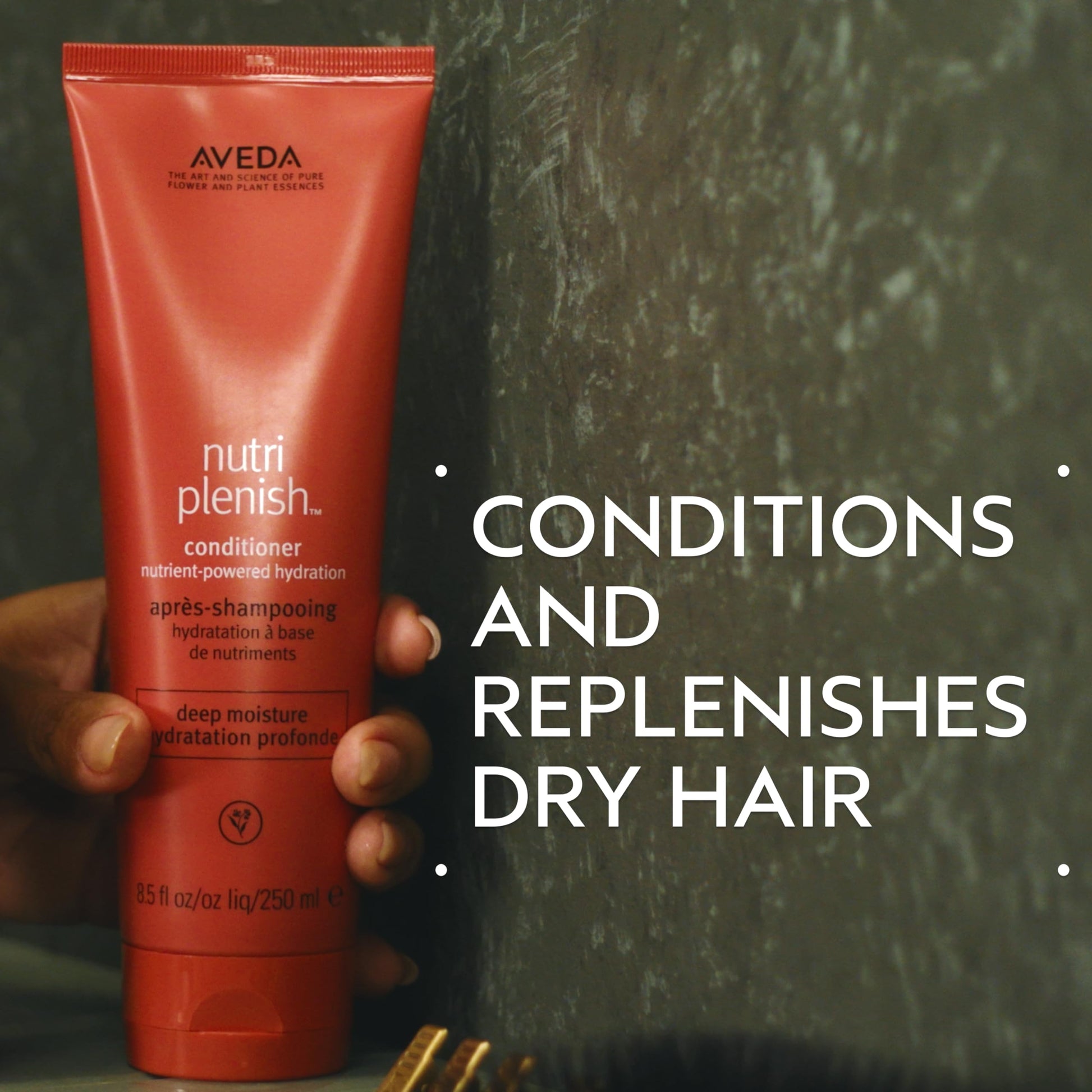 Aveda deep hydration travel size hair conditioner tube resting upright on a clean minimalist surface.