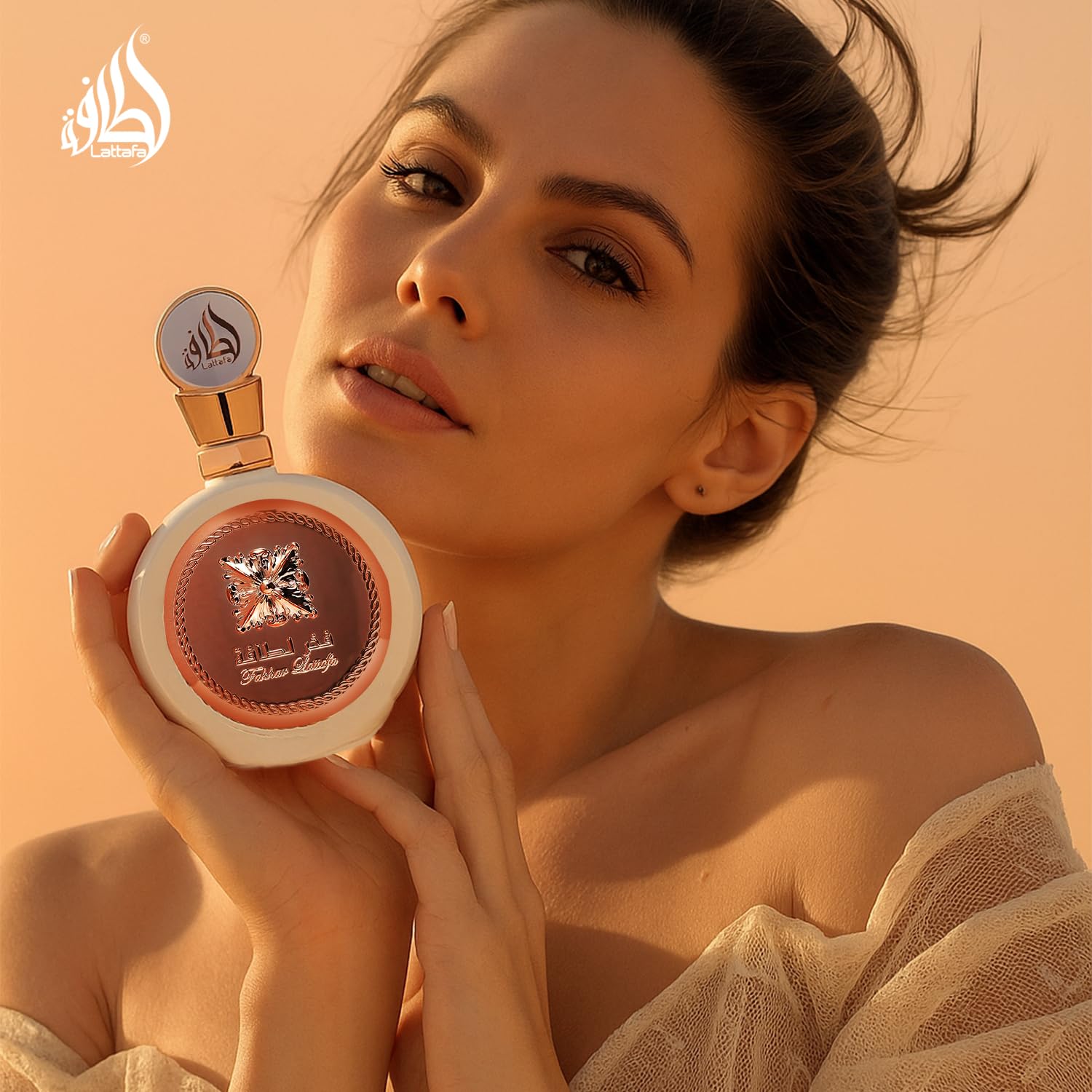 Lattafa Fakhar female perfume bottle showcasing the premium atomizer and protective cap